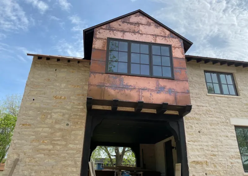 Copper metal panel facade on a stone building for Skylight Installation in Council Bluffs