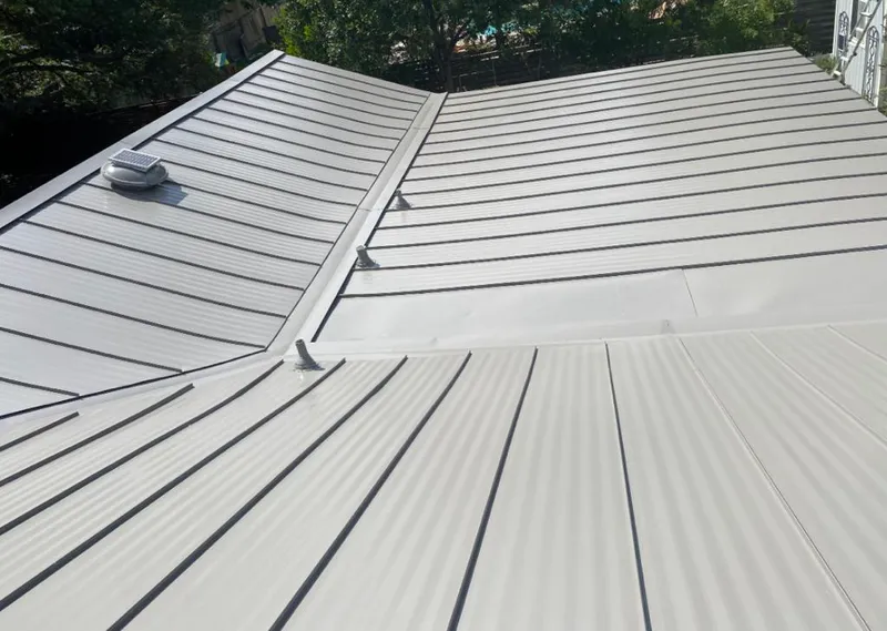 Solar attic fan installed on a metal roof for Roof Ventilation in Council Bluffs